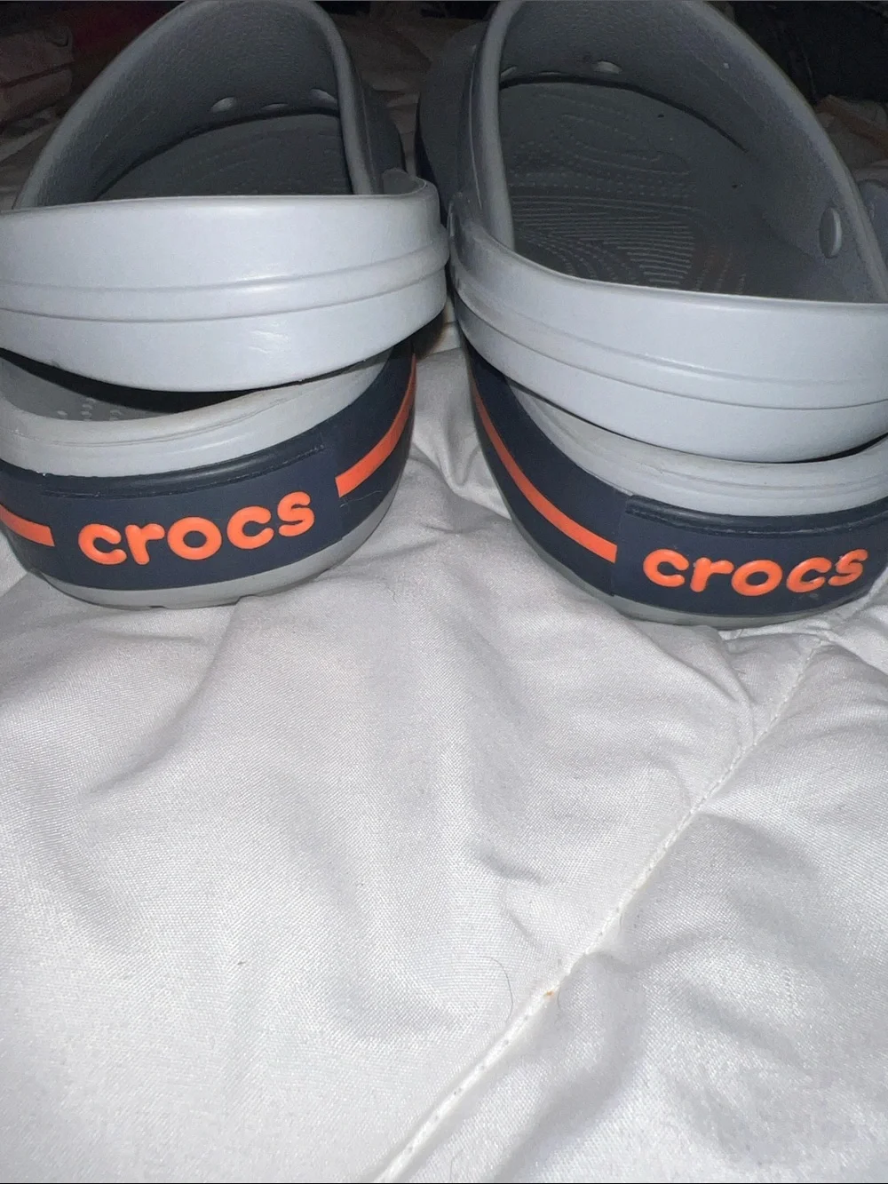 Crocs Crocband Unisex-Clogs in the light grey/navy/orange colorway. (11016-01U.)